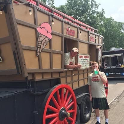 A young customer with a cone in front of the coach